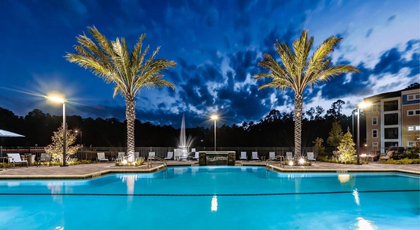 a pool with trees and buildings around it