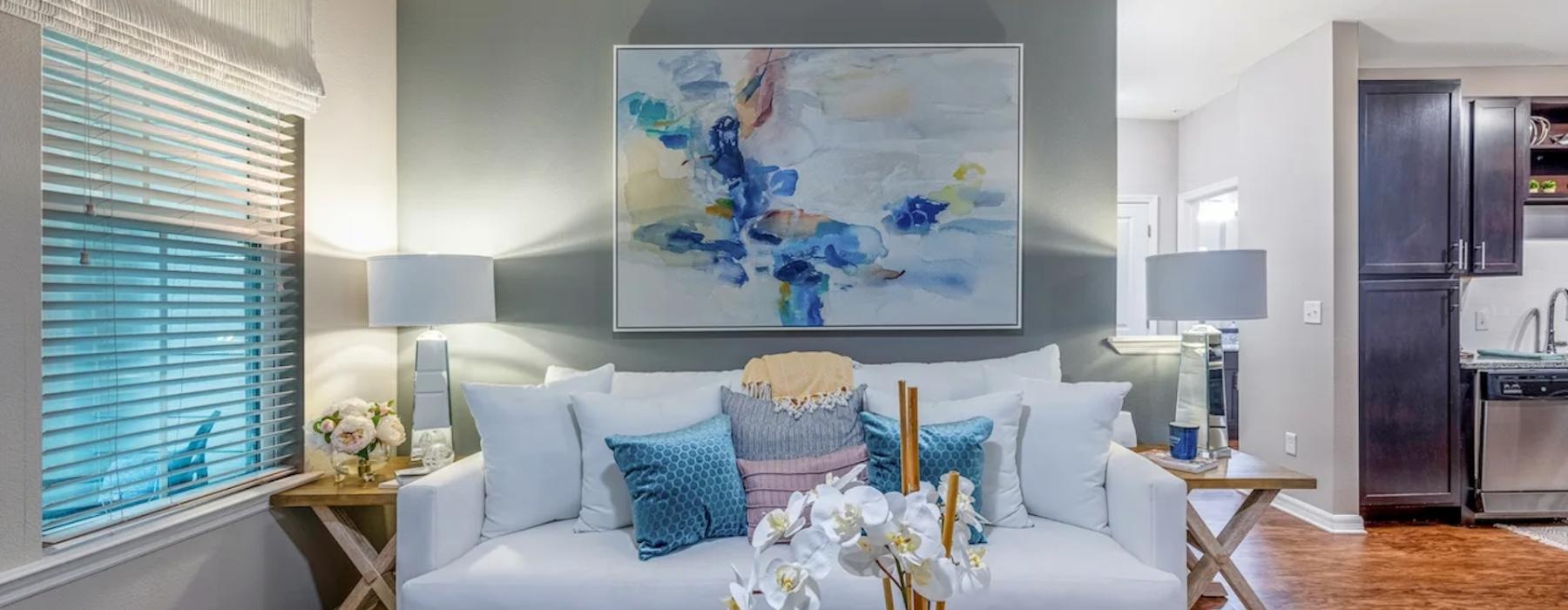 a living room with a large painting