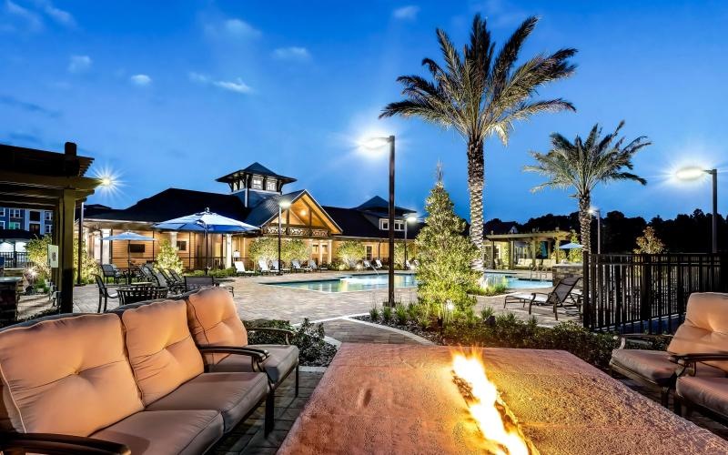 a patio with chairs and trees