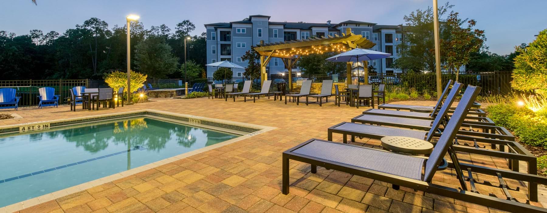 night shot of pool and loungers