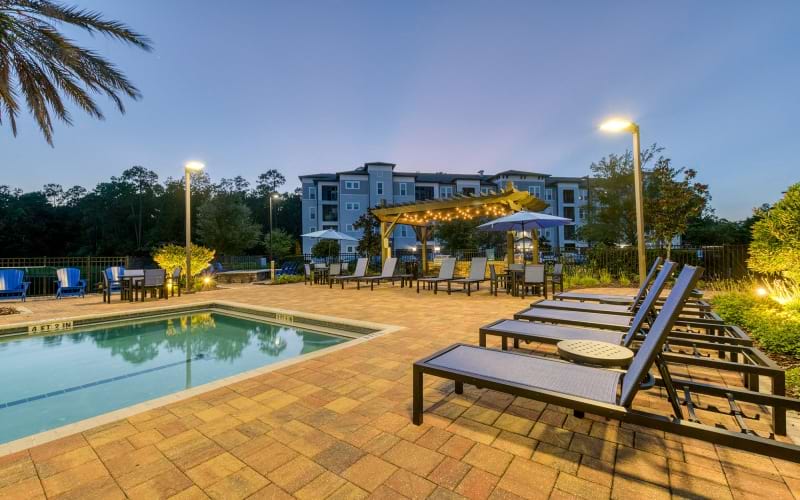 night shot of pool and loungers